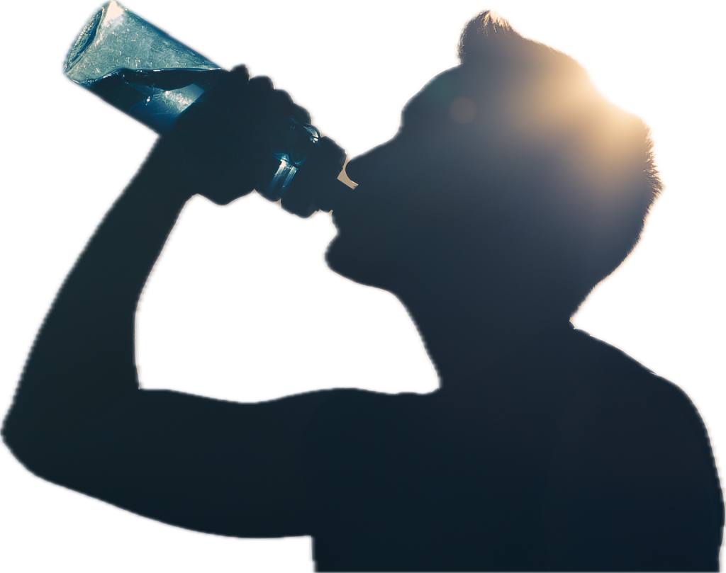 A silhouetted figure drinking from a water bottle with sunlight behind them